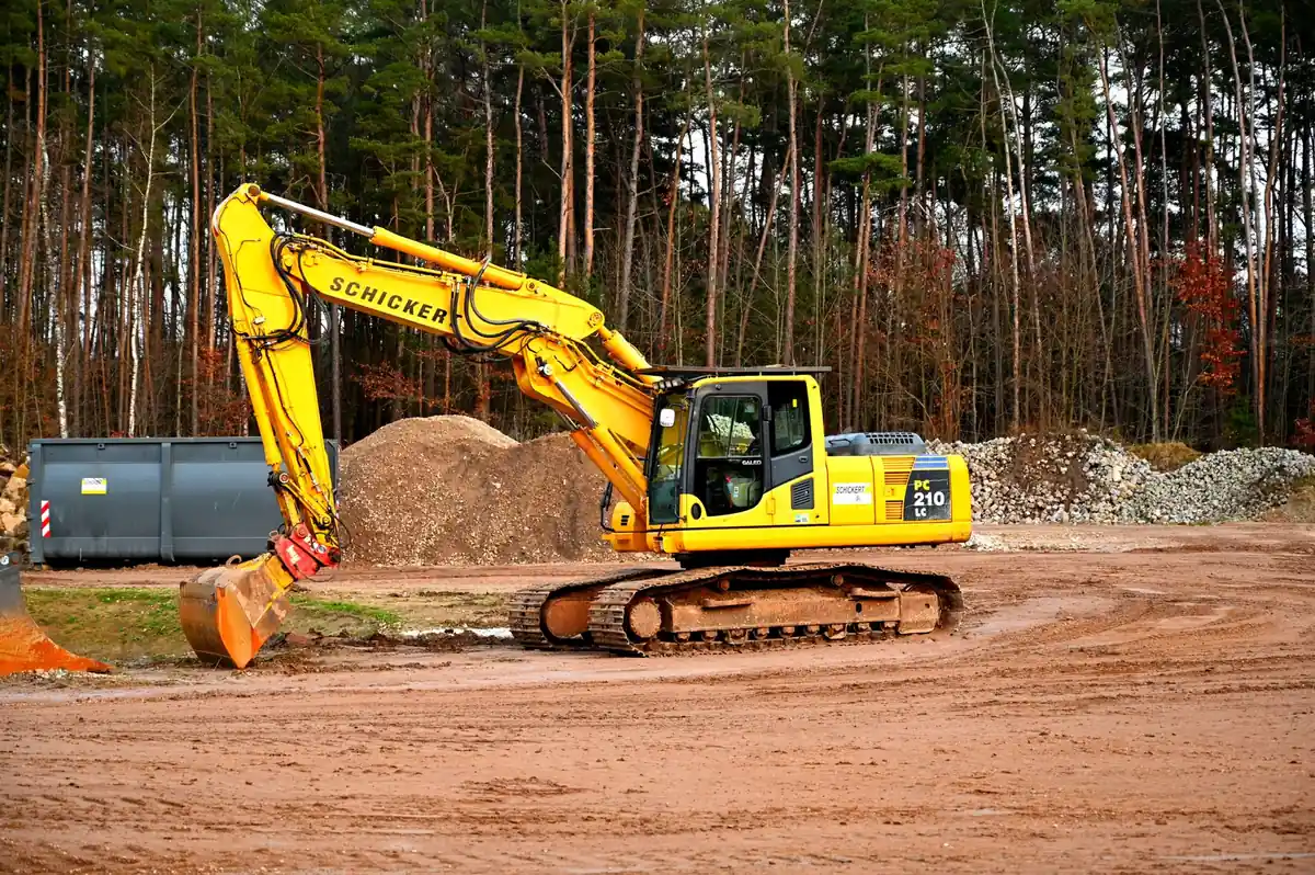 Land Clearing Gadsden County - Tallahassee Tree Service Excavator working a wooded lot during land clearing, the heavy-equipment work crews bring to Gadsden County acreage